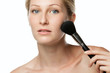 Young  female applying powder with make-up brush
