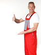Motor mechanic presenting copyspace and shows thumb up Motor mechanic presenting copyspace and shows thumb up