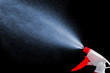 spray bottle - lighted while spraying on dark background