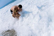 father and the son in foamy waves of the sea in summertime father and the son in foamy waves of the sea in summertime
