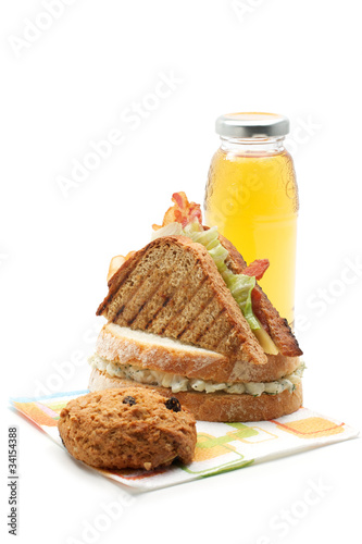 Photo: Two sandwiches, apple juice, cookie Two sandwiches, apple juice, cookie