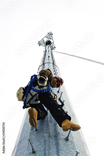 Photo: Climber starting his way up the tower Climber starting his way up the tower