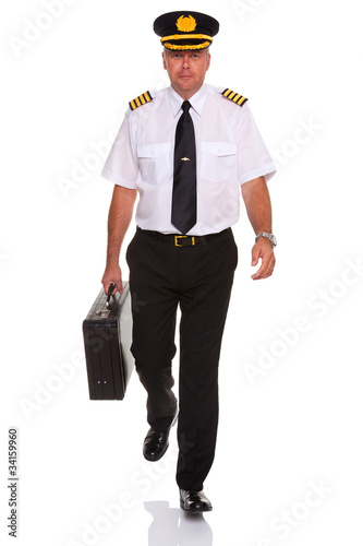 Photo: Airline pilot walking carrying flight case. Airline pilot walking carrying flight case.