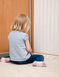 A sad girl is sitting on the floor