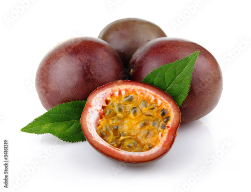 Photo: Fresh passion fruit with green leaves isolated Fresh passion fruit with green leaves isolated