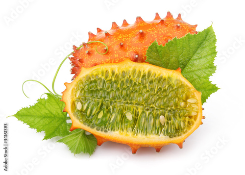 Photo: Ripe sliced kiwano fruits isolated on white Ripe sliced kiwano fruits isolated on white