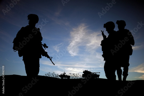 Photo: Silhouette of modern soldiers with military vehicles Silhouette of modern soldiers with military vehicles