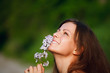 Happy young woman and wild flowers.