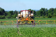 Close up of tractor spraying pesticides on crop