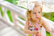 Photo: close-up portrait of beauty little girl with flower in her hair close-up portrait of beauty little girl with flower in her hair