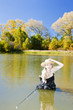 woman fishing in pond
