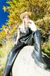 fisher woman sitting on stone