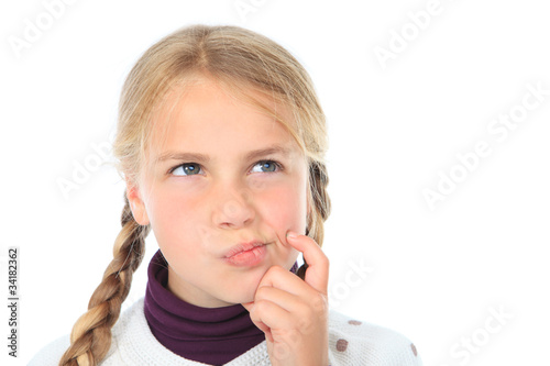 Photo: little girl in thought isolated on white with copyspace little girl in thought isolated on white with copyspace