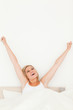 Portrait of a young woman stretching her arms