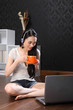 Beautiful chinese girl drinking tea using internet