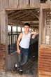 Boy standing at old barn Boy standing at old barn