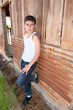 Boy standing against old barn Boy standing against old barn