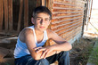 Boy sitting in old barn Boy sitting in old barn