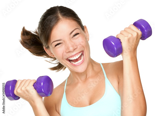 Photo: Happy fitness woman lifting dumbbells Happy fitness woman lifting dumbbells