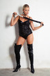 beautiful woman on high heels holding a whip