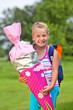 little girl with school bag and school cone outdoor smiling scho