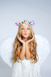 Angel little girl blowing expression with wings