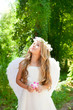 Angel children girl holding flower in hand looking sky