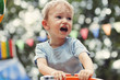 Cute little boy crying at a party
