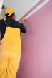 Photo: painting a wall pink by painters construction workers painting a wall pink by painters construction workers