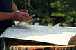 Man looking at map and compass in the woods
