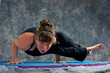 woman doing yoga posture Astavakrasana or  Ancient Sage with Cro