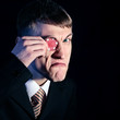 gambling, man with a red chip - monocular, on black