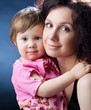 portrait of beautiful mother with cute young girl