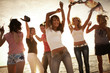 young people dancing at the beach