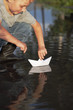 paper ship in children hand