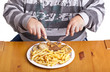 fat man eating a bunch of steaks and french fries