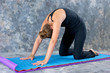 Photo: woman doing Yoga posture Marjaryasana or cat pose woman doing Yoga posture Marjaryasana or cat pose