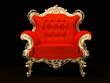 Royal armchair with gold frame isolated on black background