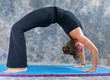Photo: woman doing yoga exercise full wheel pose on on mat in studio woman doing yoga exercise full wheel pose on on mat in studio