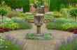 English sumer garden with stone vase and flags English sumer garden with stone vase and flags