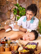 Woman getting thai herbal compress massage . Woman getting thai herbal compress massage .