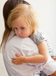 a mother is holding a sick girl.