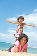ethnic girl fun with mother on tropical beach