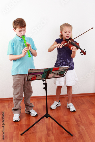 Photo: Kids playing flute and violin Kids playing flute and violin
