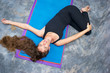 Photo: from above woman doing yoga posture Ardha Jathara Parivarttanasa from above woman doing yoga posture Ardha Jathara Parivarttanasa