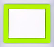 Empty green paper frame with white background on gray wall