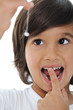 Lost milk tooth, cute boy with long hair