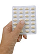 Hand with HRT - hormone replacement therapy tablets, isolated ov Hand with HRT - hormone replacement therapy tablets, isolated ov