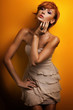 Fashion photo of beautiful redhead girl posing in sensual dress