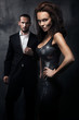 Fashionable couple in a dark room